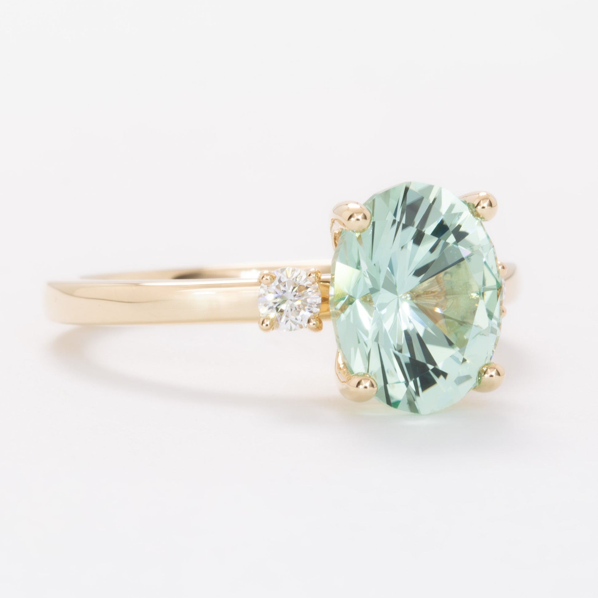 naomi three stone engagment ring with mint oval lab sapphire