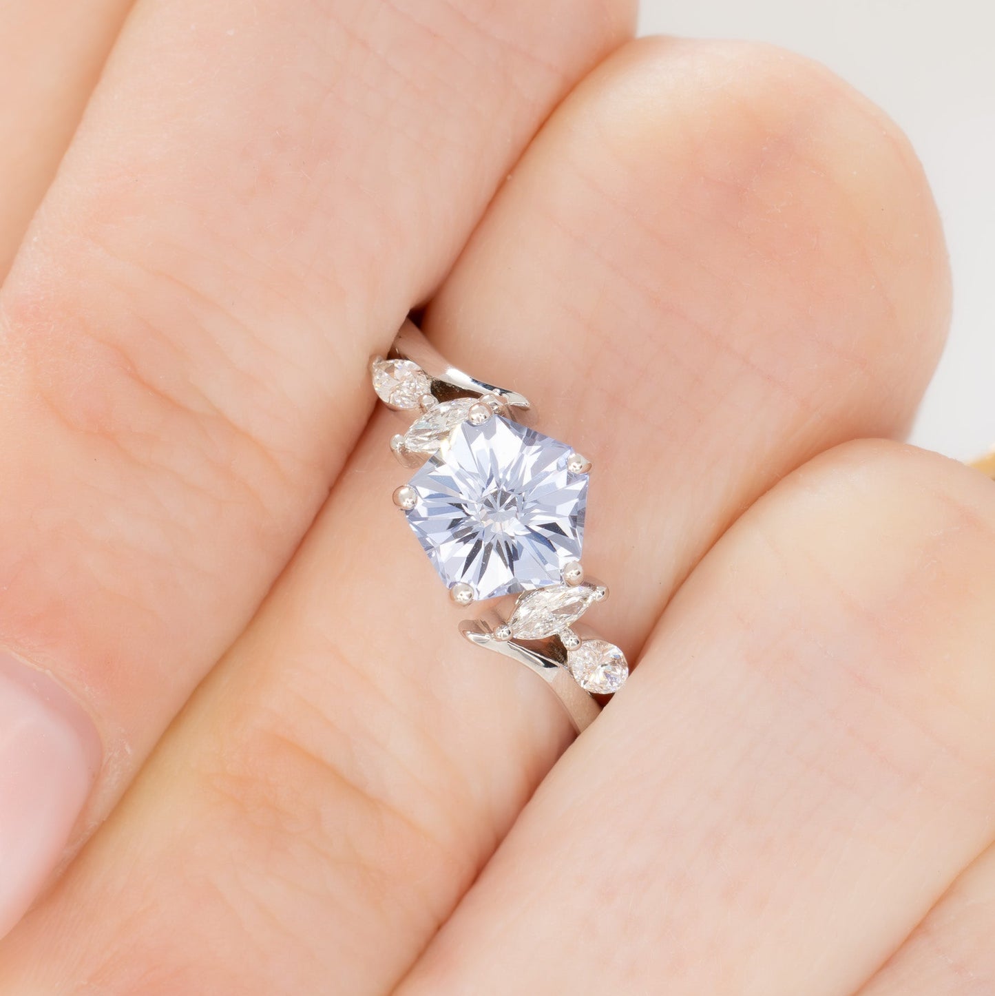 nature inspired engagement ring in white gold with light blue lab sapphire hanami pentagon