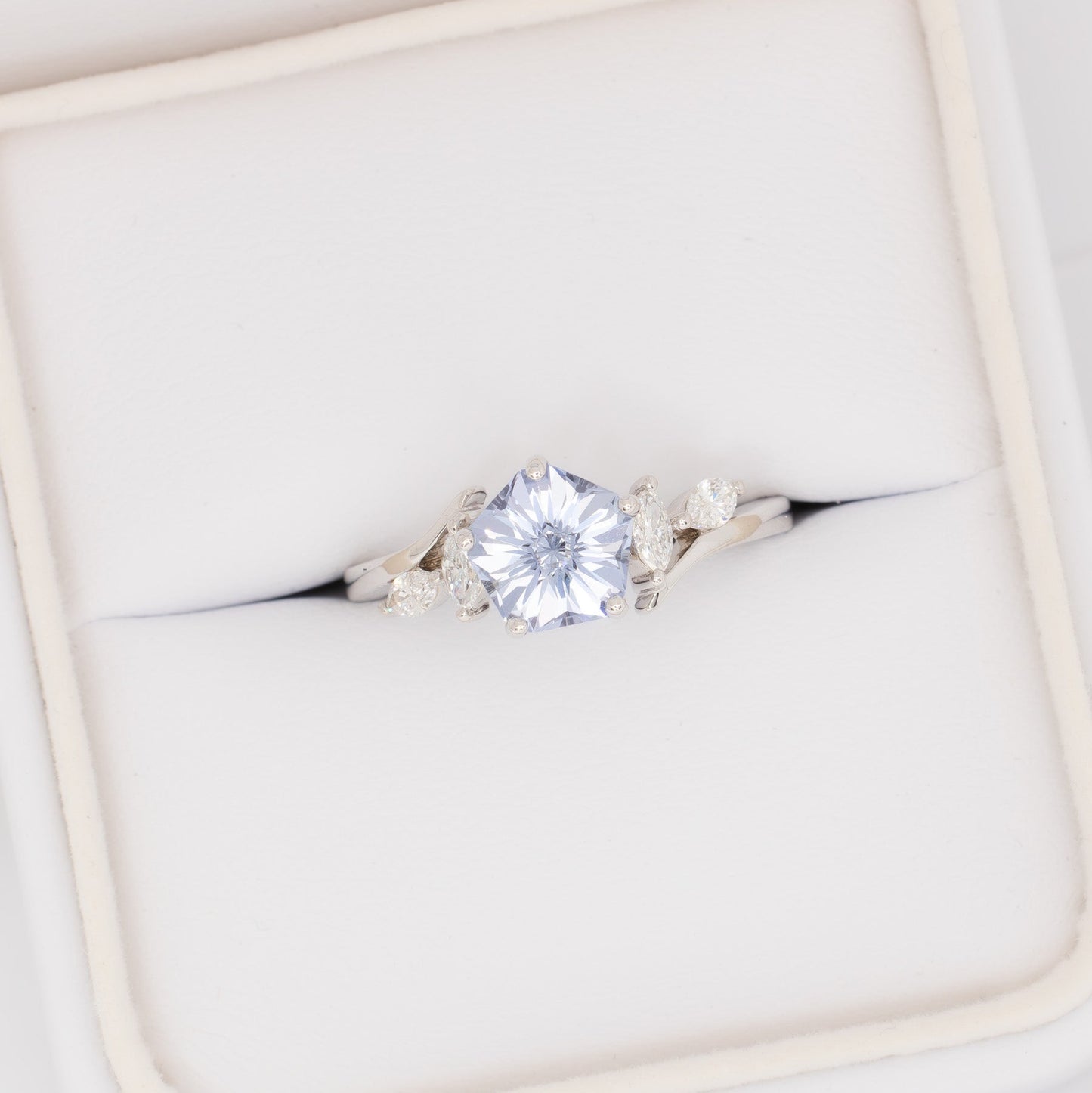 nature inspired engagement ring in white gold with light blue lab sapphire hanami pentagon