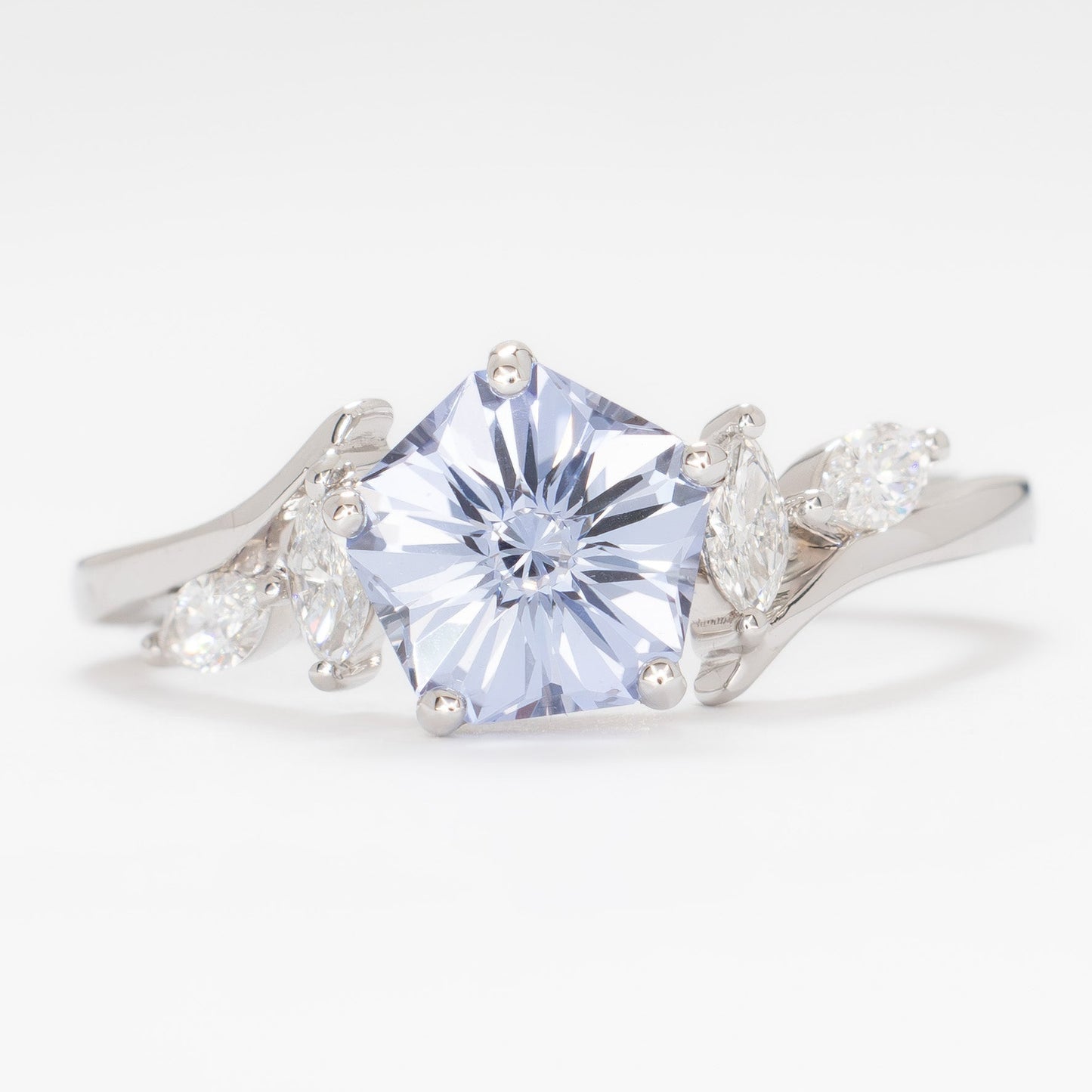 nature inspired engagement ring in white gold with light blue lab sapphire hanami pentagon