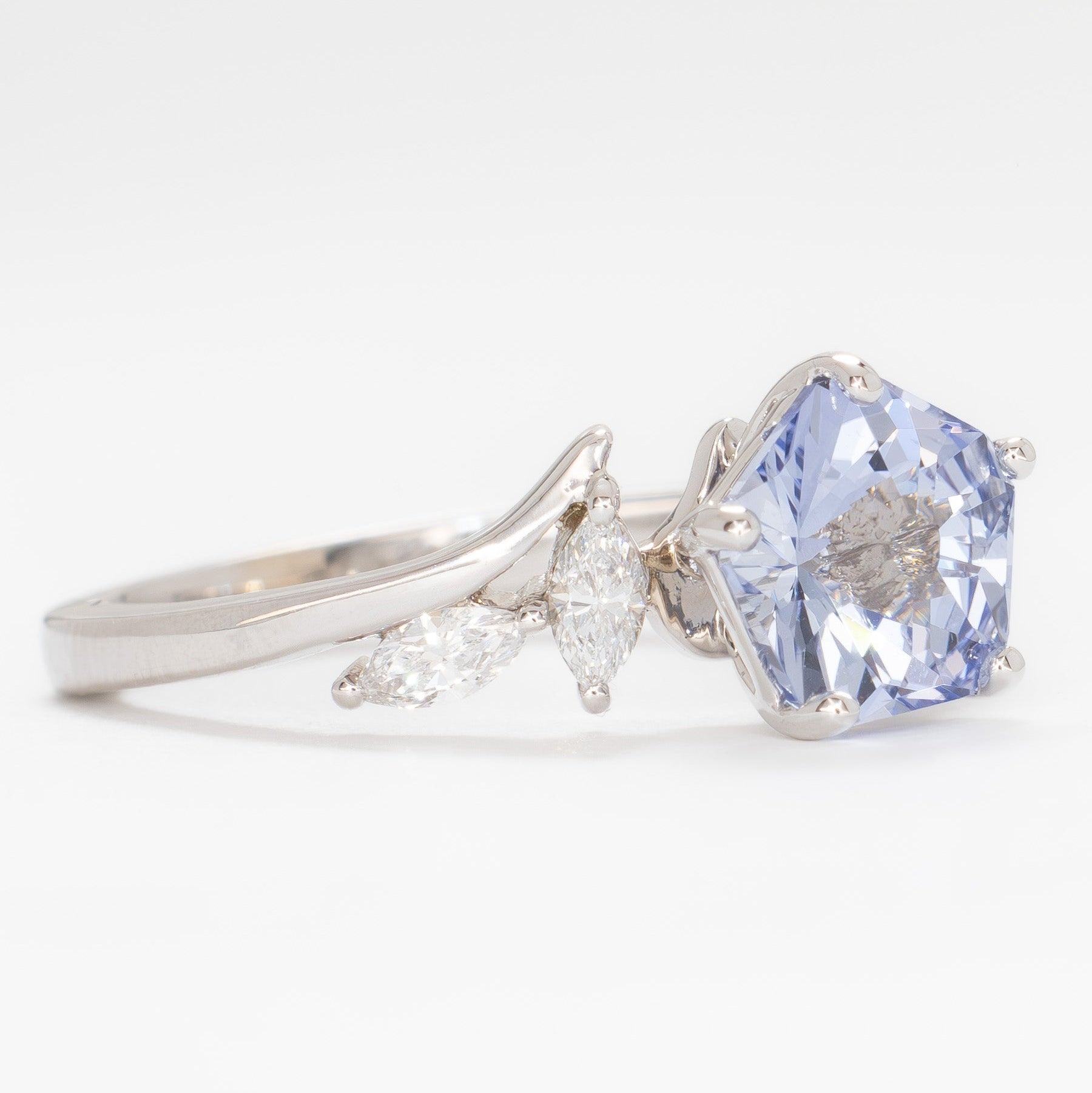 nature inspired engagement ring in white gold with light blue lab sapphire hanami pentagon