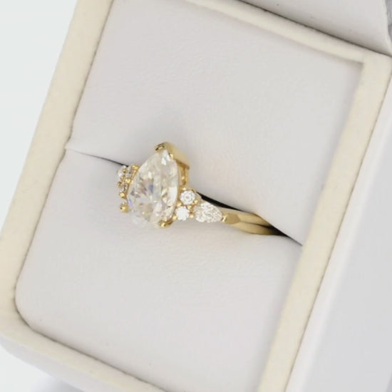 pear moissanite accented engagement ring in yellow gold