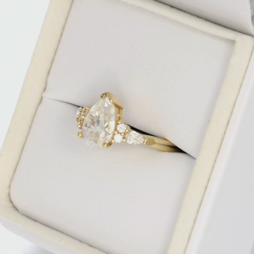pear moissanite accented engagement ring in yellow gold