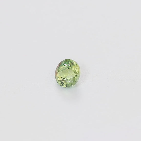 AF0115 0.62ct stormlight round bi-color yellow green montana sapphire