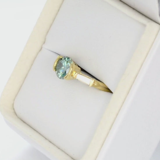 ezri three stone engagement ring with round blue-green moissanite in yellow gold
