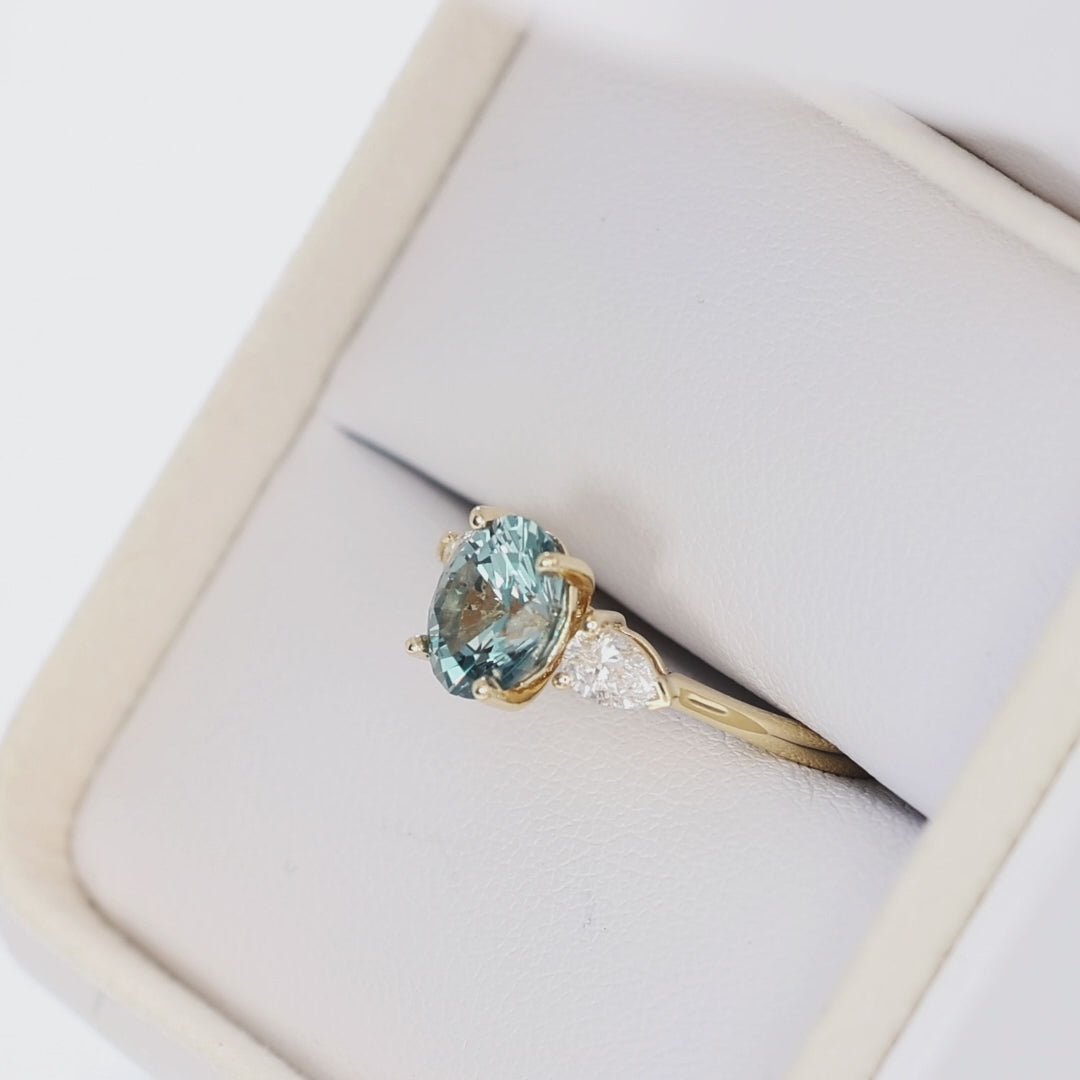 beckett three stone ring in yellow gold with oval blue-green lab sapphire