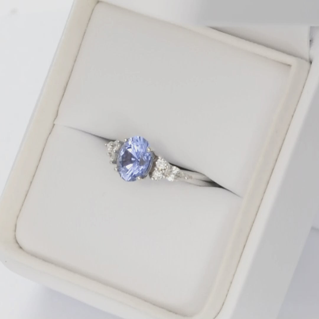 accented white gold engagement ring with oval blue lab sapphire