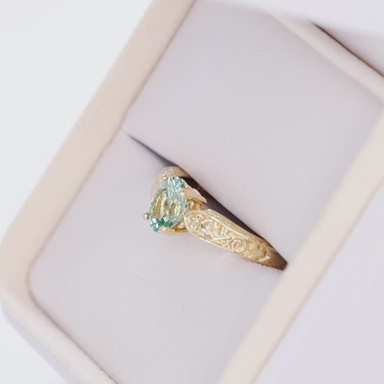 flora nature inspired ring in yellow gold with light green lab sapphire oval