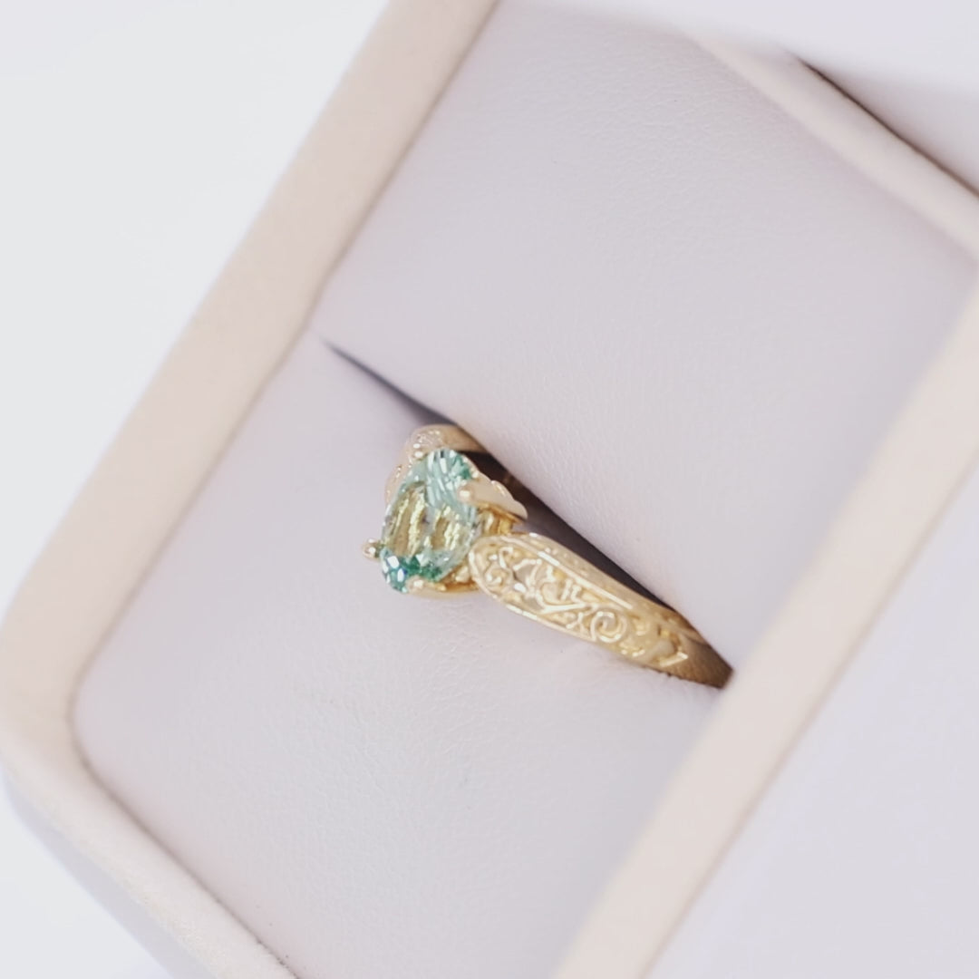 flora nature inspired ring in yellow gold with light green lab sapphire oval