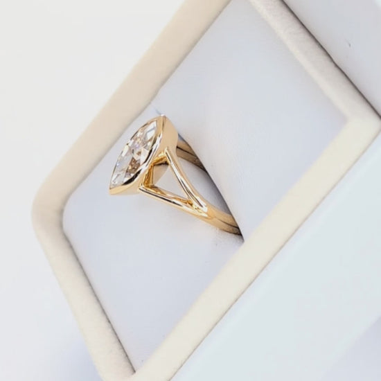 shion bezel set split shank solitaire with marquise moissanite