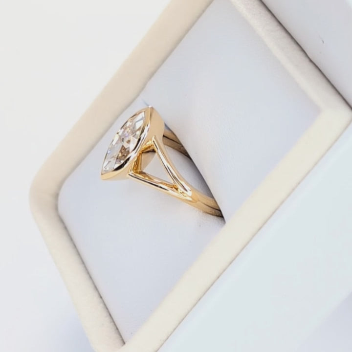 shion bezel set split shank solitaire with marquise moissanite
