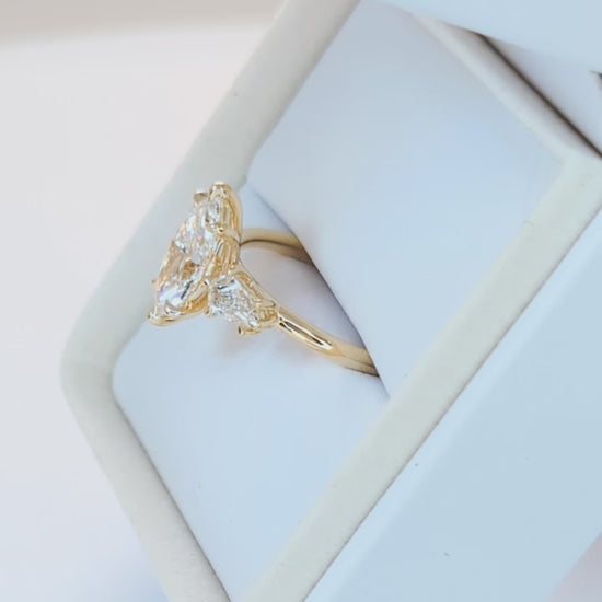 felicity three stone engagement ring with marquise lab diamond
