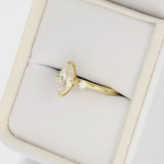 yellow gold 3 stone ring with moissanite marquise