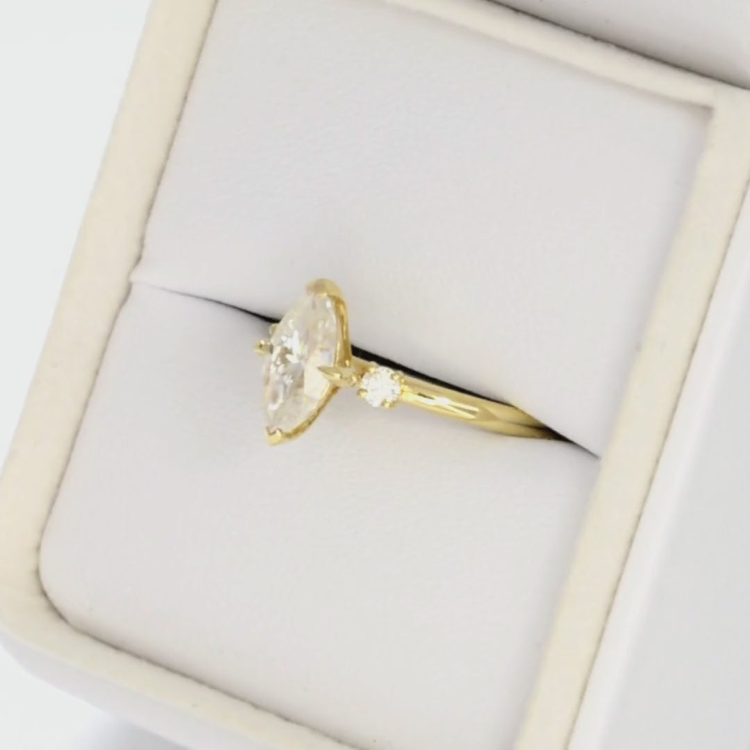 yellow gold 3 stone ring with moissanite marquise