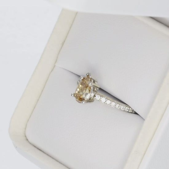 liv accented ring in white gold with golden pear moissanite