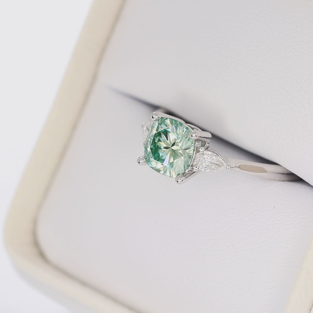 lacey three stone ring with cushion blue-green moissanite