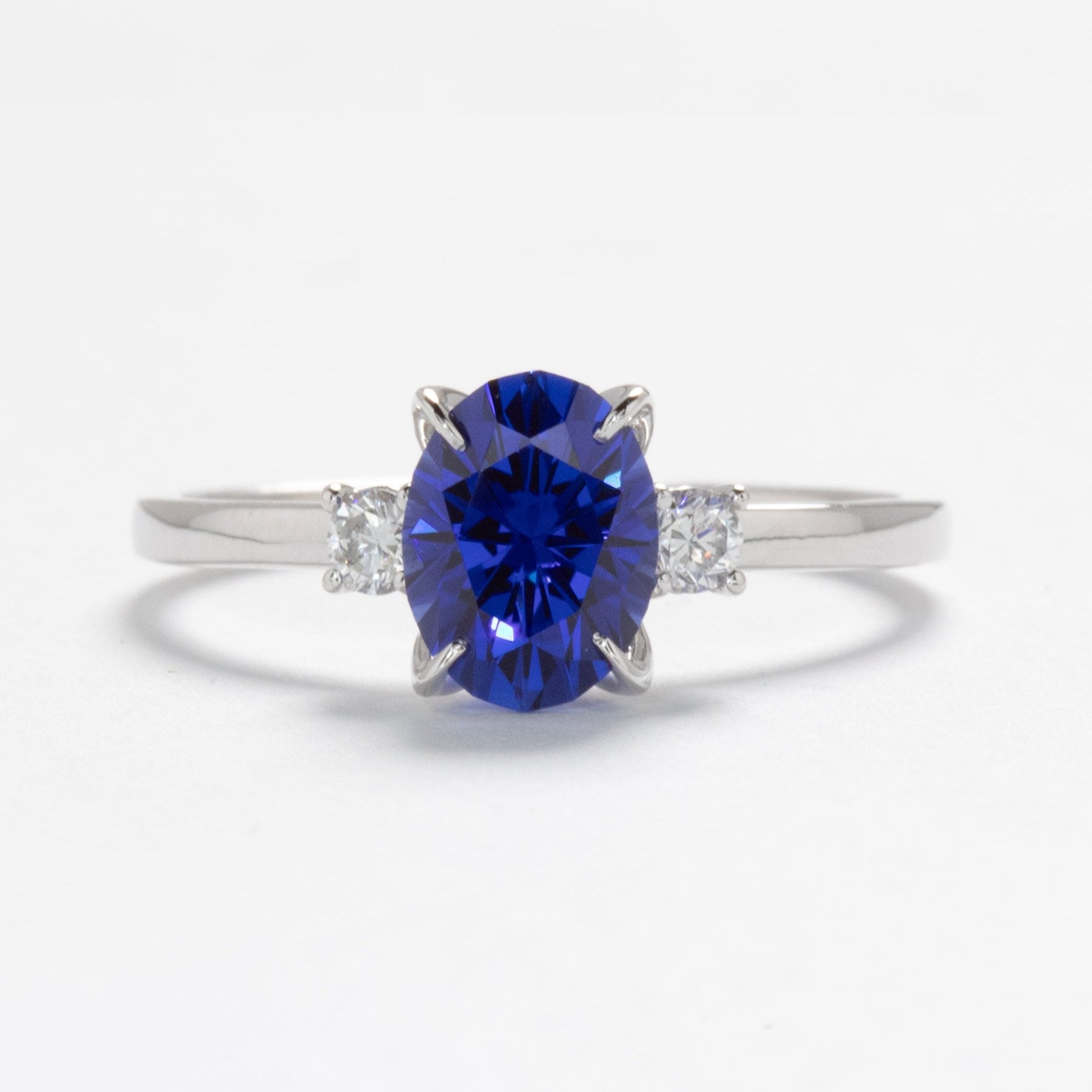 royal blue lab sapphire three stone engagement ring in white gold