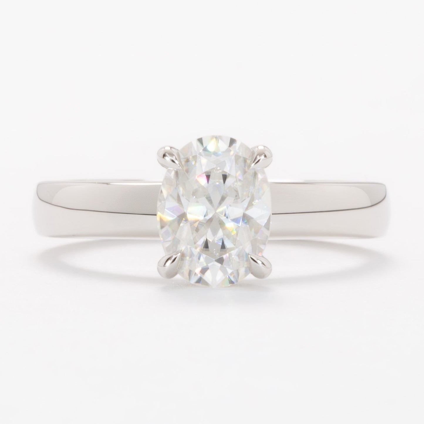 serene solitaire ring with wide band and oval white moissanite