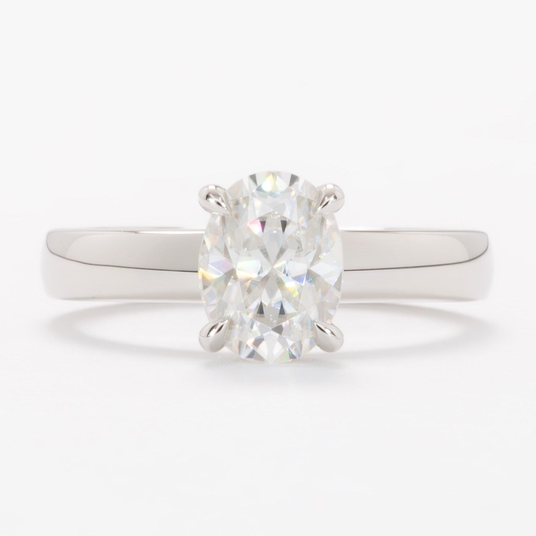 serene solitaire ring with wide band and oval white moissanite