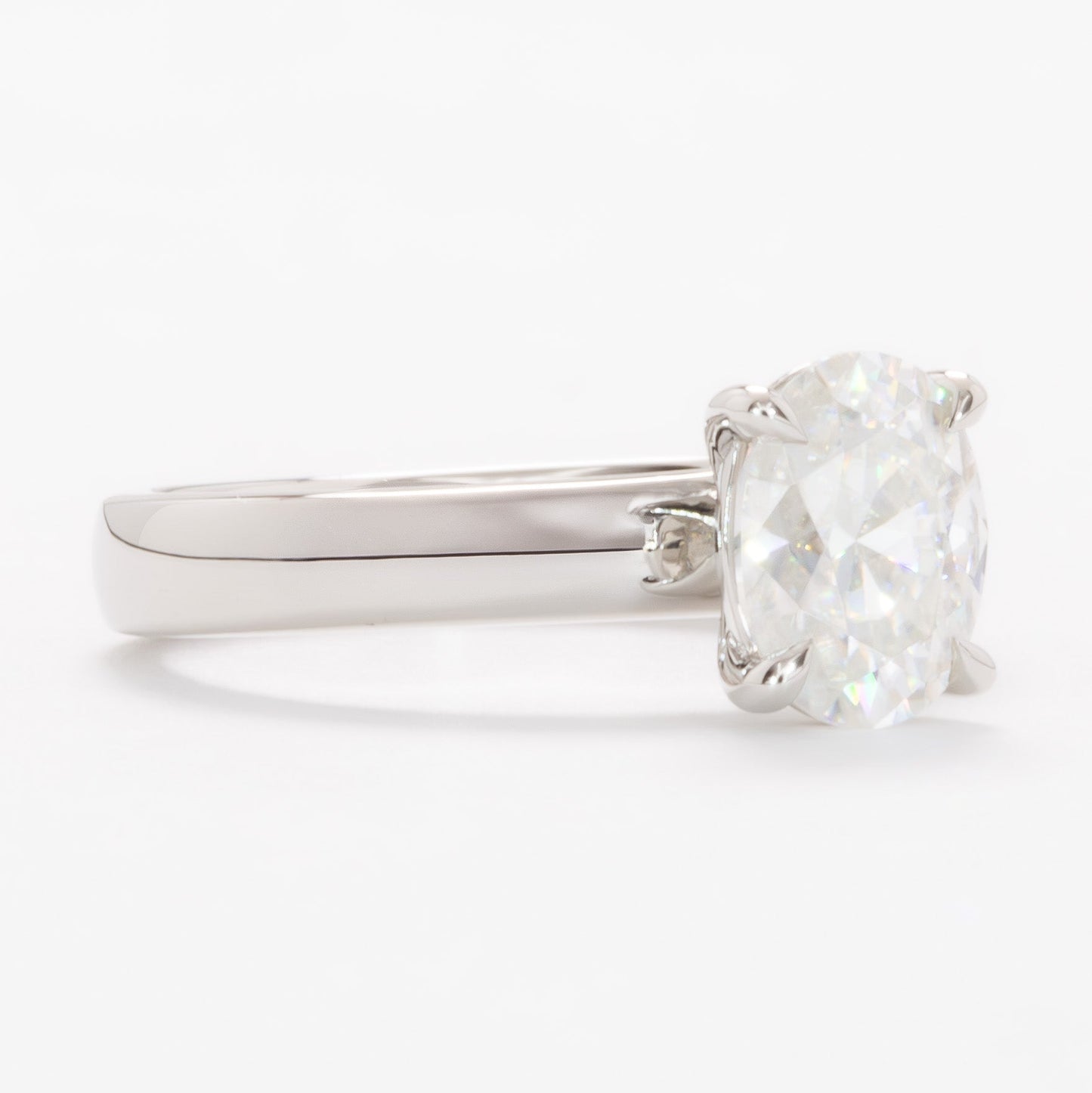 serene solitaire ring with wide band and oval white moissanite