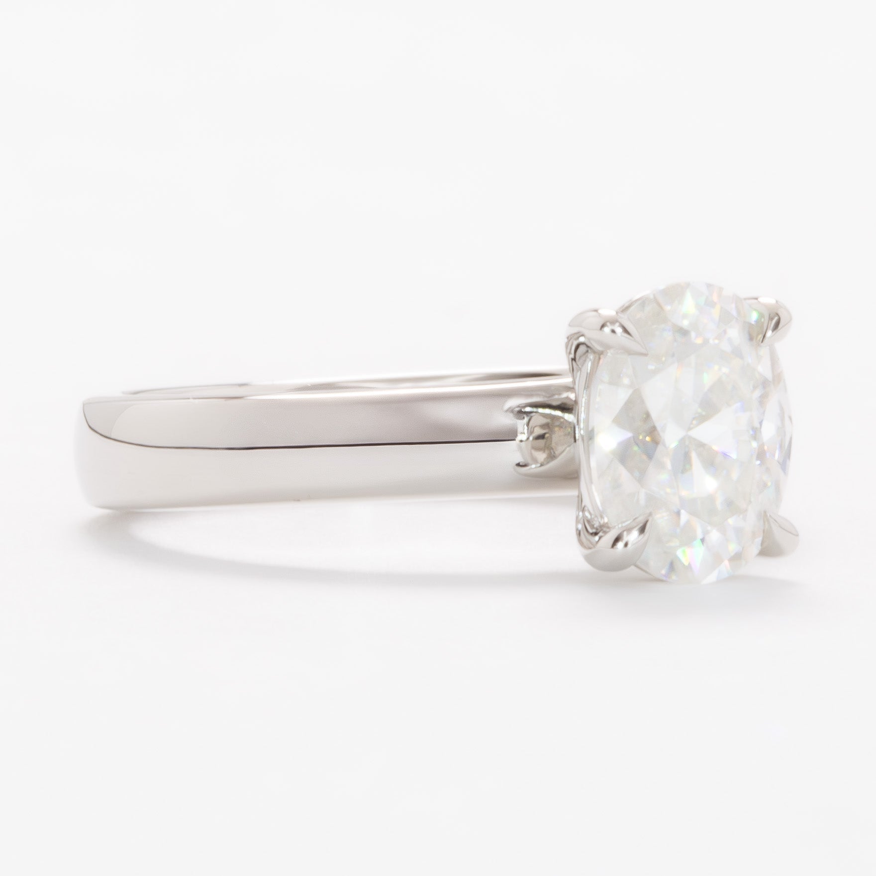 serene solitaire ring with wide band and oval white moissanite