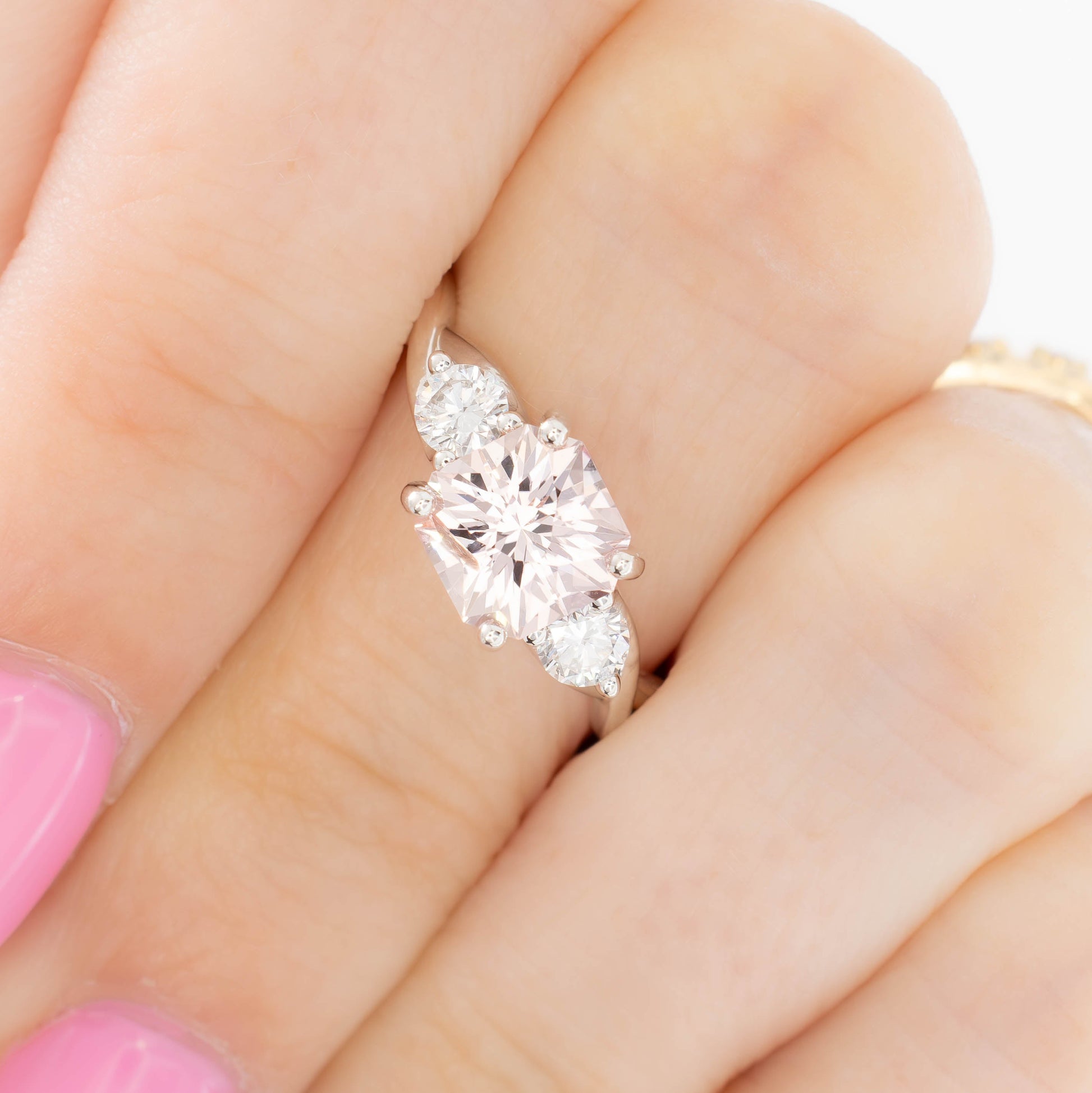 shasta three stone ring in silver with peach lab sapphire asscher