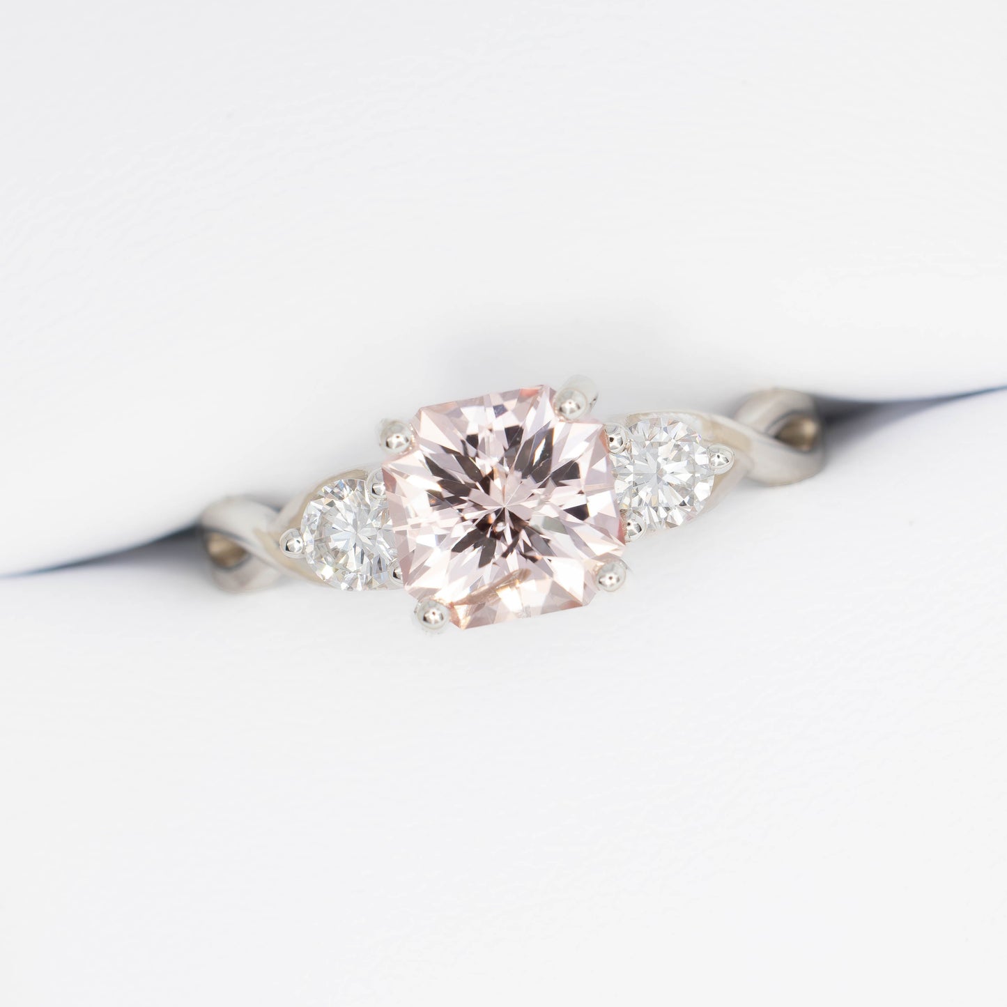 shasta three stone ring in silver with peach lab sapphire asscher