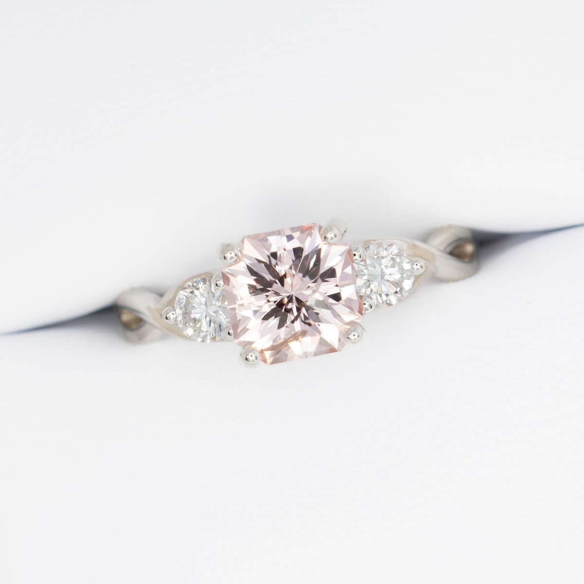 shasta three stone ring in silver with peach lab sapphire asscher