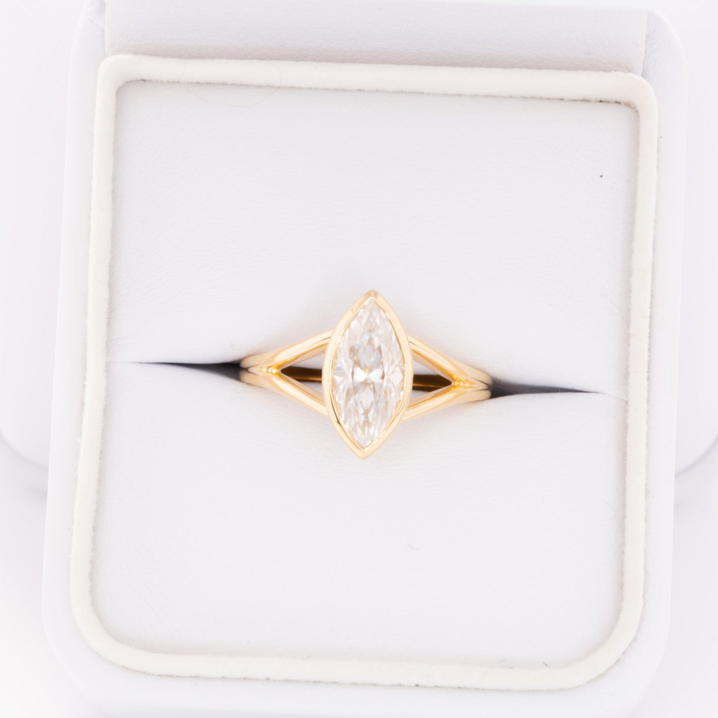 shion bezel set split shank solitaire with marquise moissanite