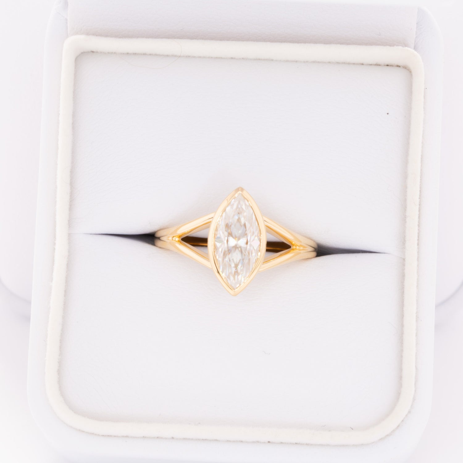 shion bezel set split shank solitaire with marquise moissanite