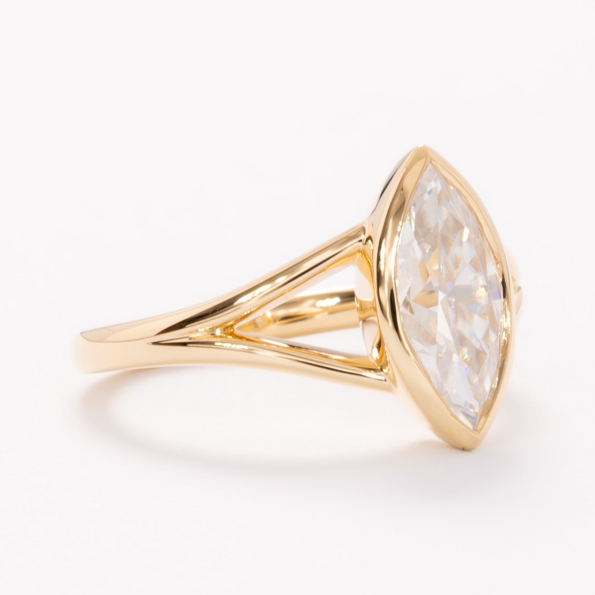 shion bezel set split shank solitaire with marquise moissanite