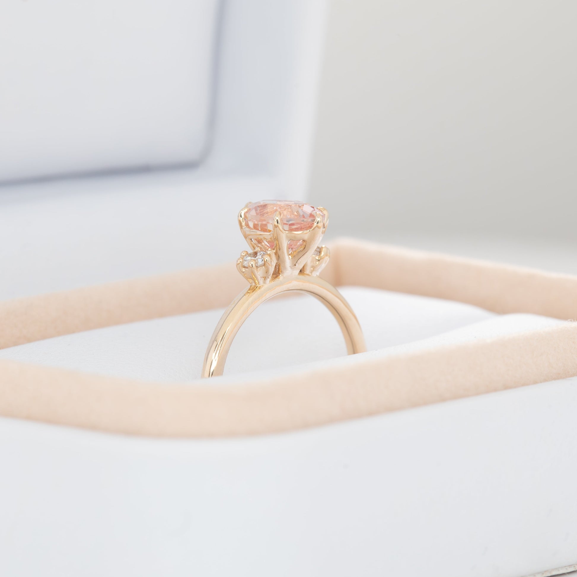 signy engagement ring with oval peach lab sapphire