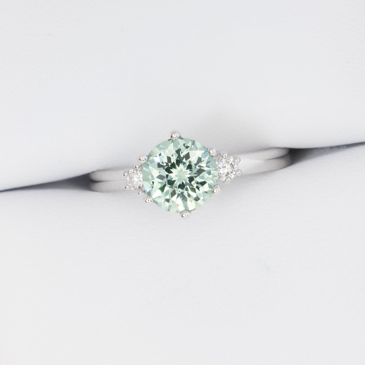 signy three stone ring in white gold with round green lab sapphire
