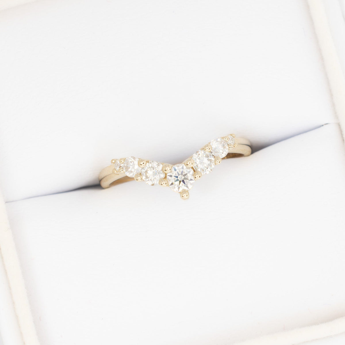 stella contour band in yellow gold with moissanite accents