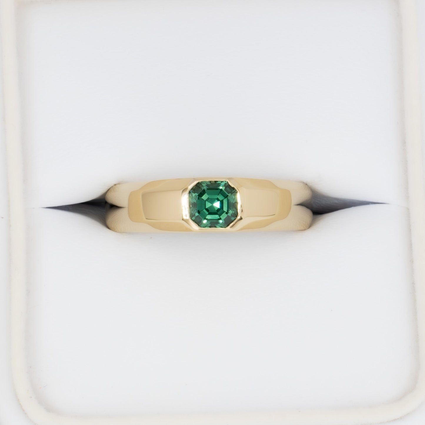 stevie flush set ring in yellow gold with green lab sapphire asscher