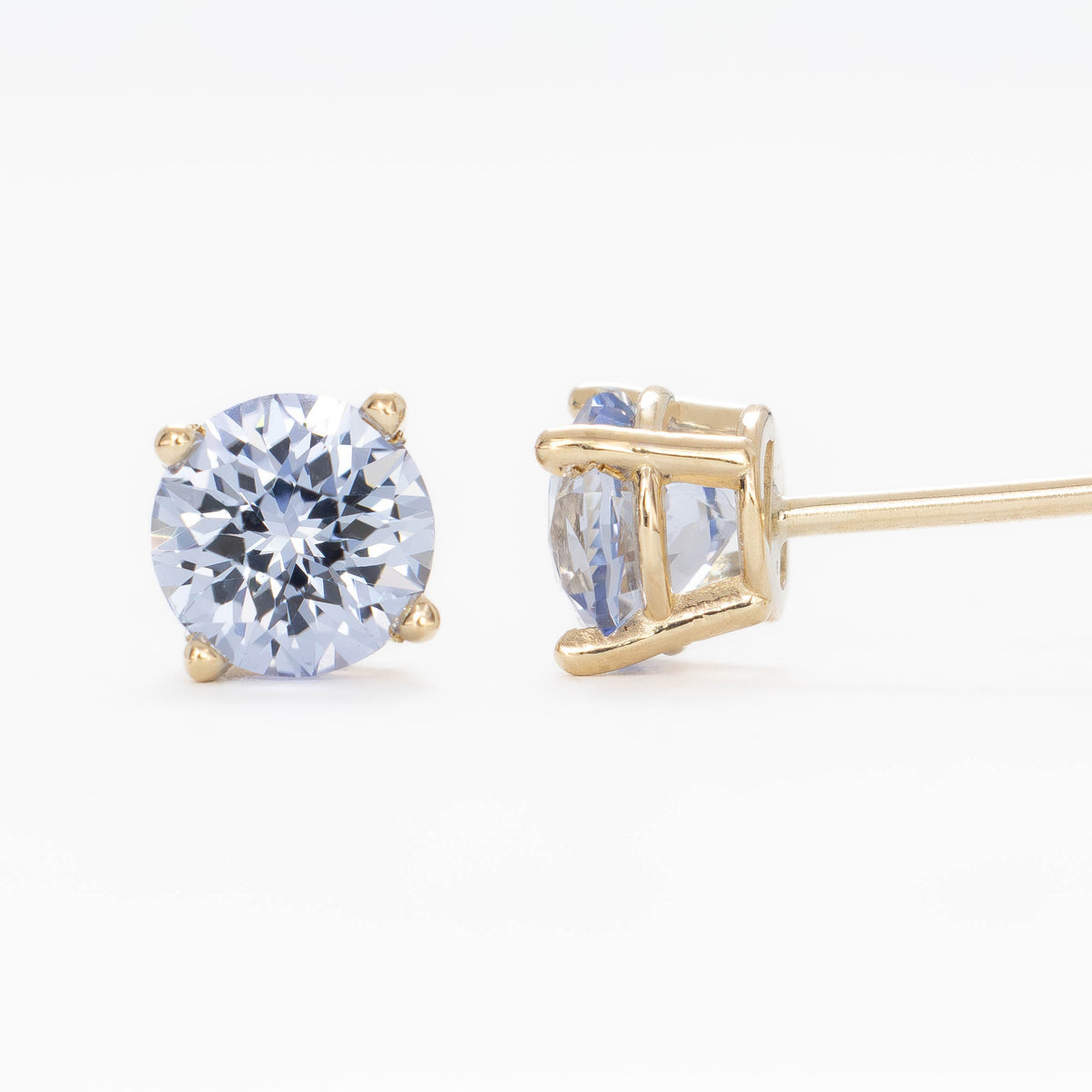 zoe earrings in yellow gold with light blue lab sapphire rounds